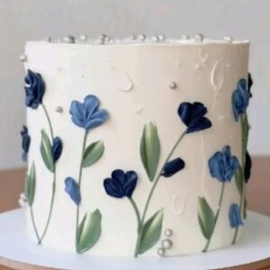 White cake with blue flowers and leaves