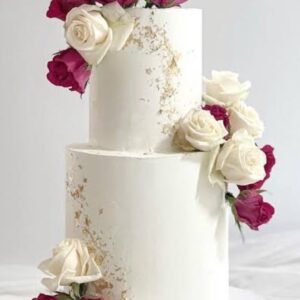 Two tier white cake with red and white flowers