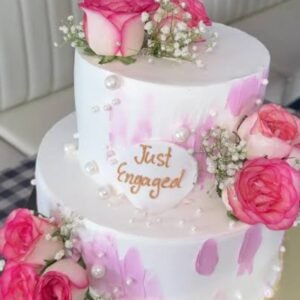 Two tier white cake with pink flowers