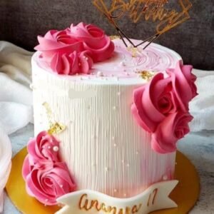 White cake with pink flowers and pearls
