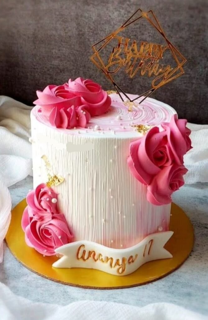 White cake with pink flowers and pearls