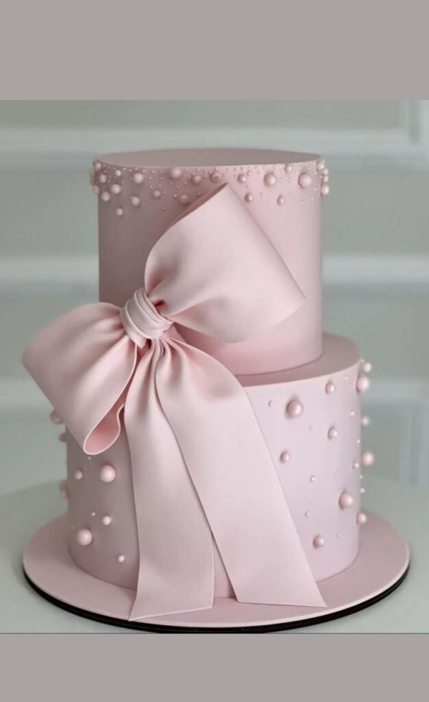 Pink cake with pink bow and pearls