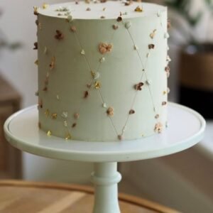 White cake with straight crossing lines and small flowers