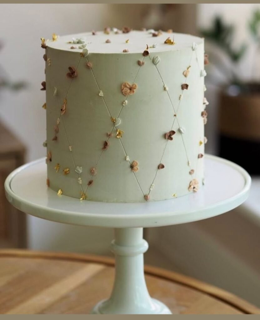 White cake with straight crossing lines and small flowers