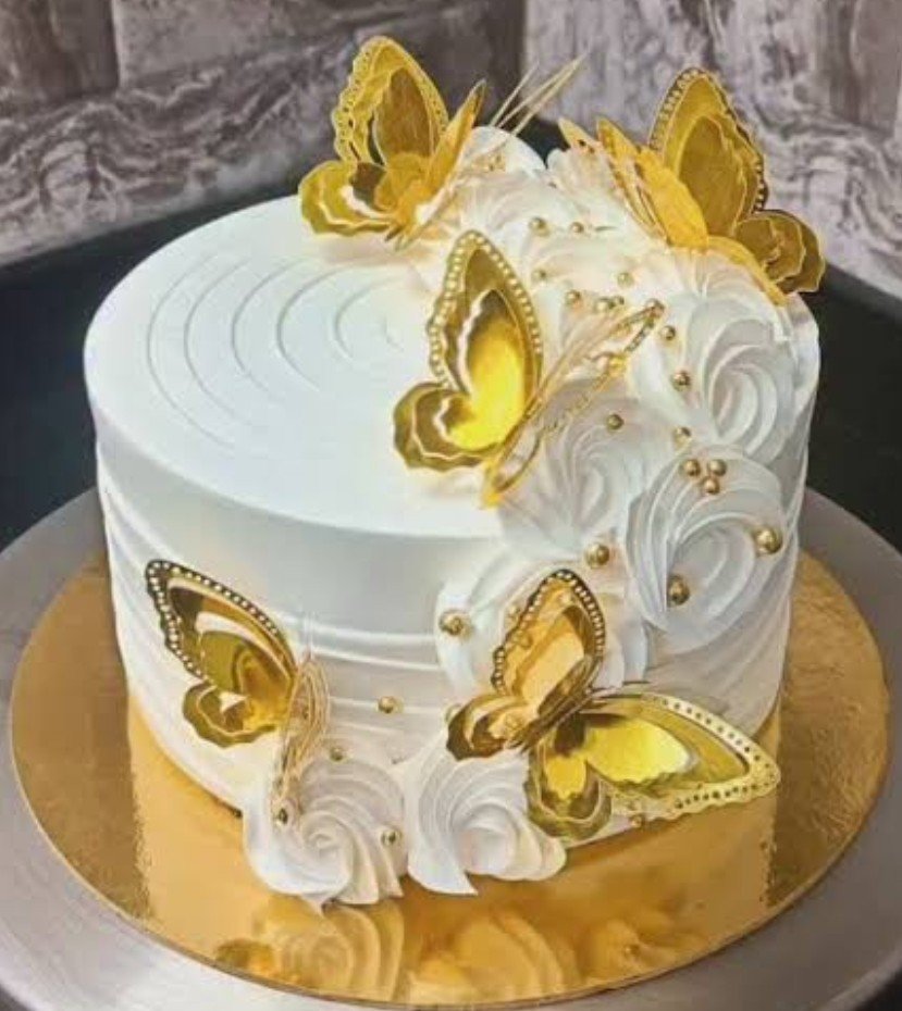 White cake with golden butterflies