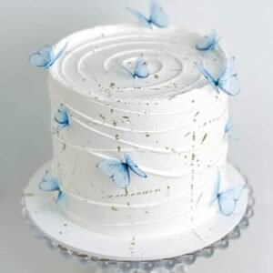 Beautiful white cake with blue butterflies