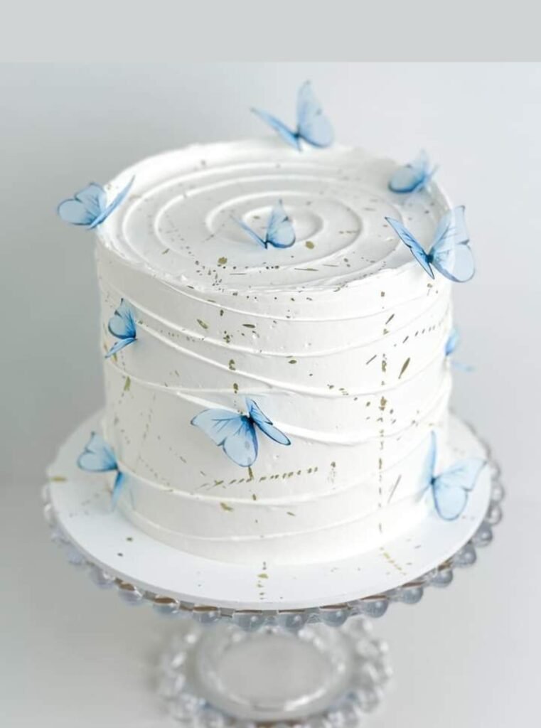 Beautiful white cake with blue butterflies