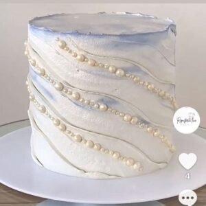 Shiny white cake with diagonal beads lines