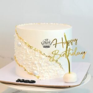 Birthday cake with diagonal gold and pearls lines