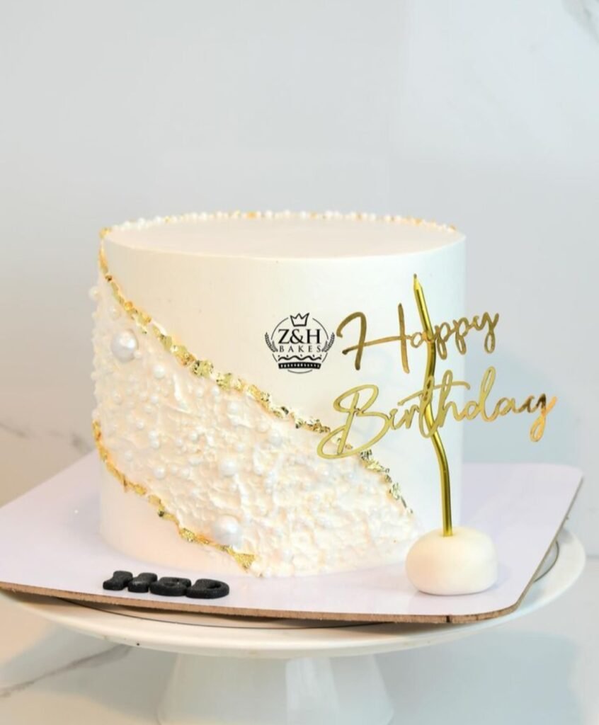 Birthday cake with diagonal gold and pearls lines