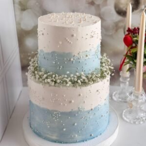 Tall two tier white and light blue themed cake