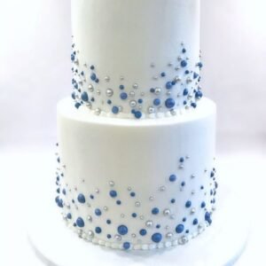White double tier cake with silver and blue beads