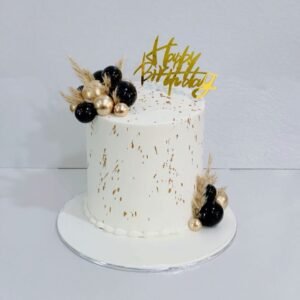 White tall cake with gold dust spray