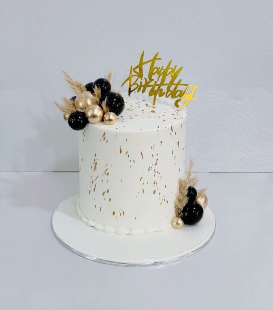 Black and white themes cake with golden and black balls