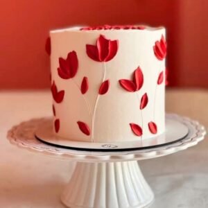 White cake with red flower vine