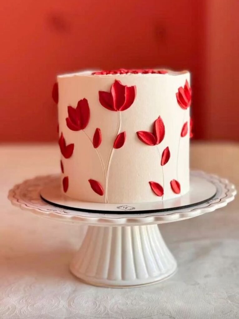 White cake with red flower vine