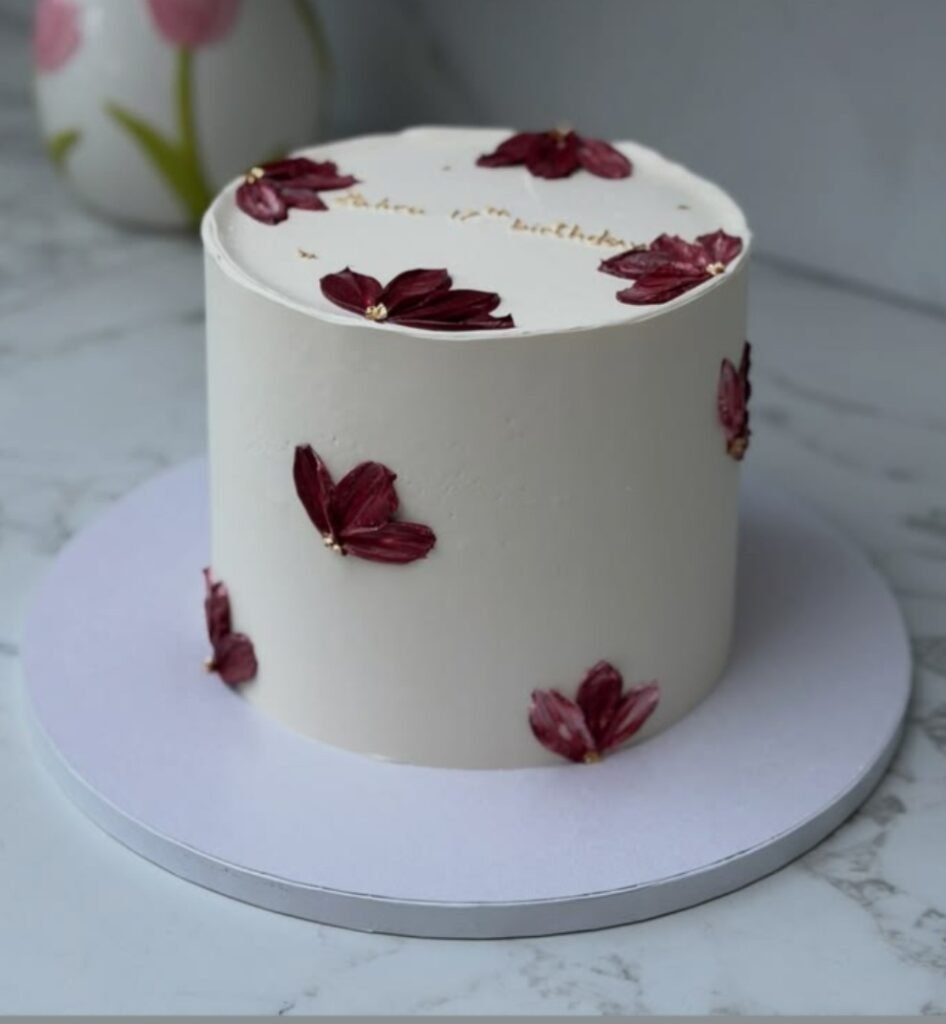 White cake with red petals
