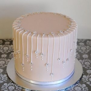 Off white cake with semi fondand threads with beads