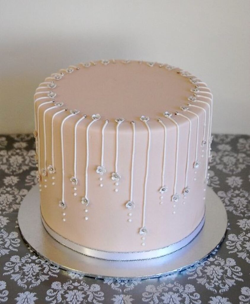 Off white cake with semi fondand threads with beads