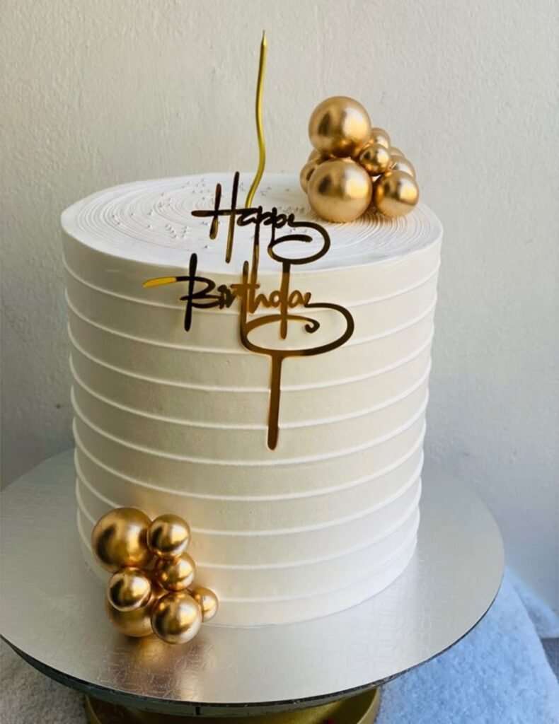 White tall cakes with golden balls