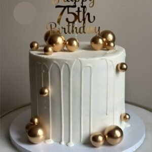 White tall cake with golden balls