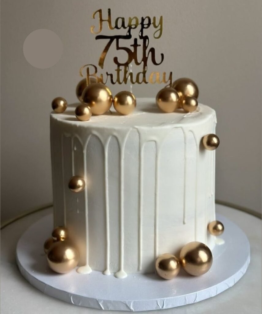 White tall cake with golden balls