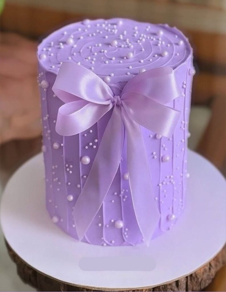 Beautiful tall purple cake with purple lace bow